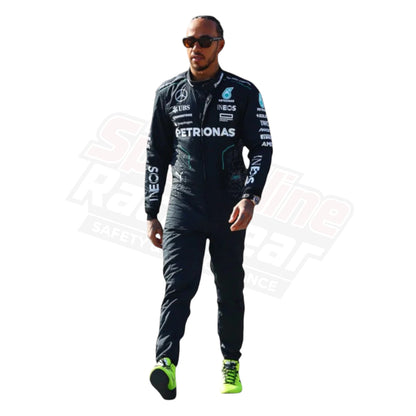 Racer dressed in a black racing suit with visible brand logos, standing against a white background.