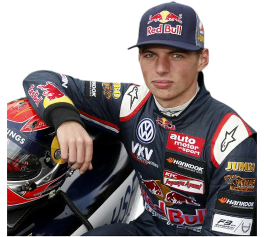 A person wearing a racing suit with various sponsor logos, sitting beside a helmet.